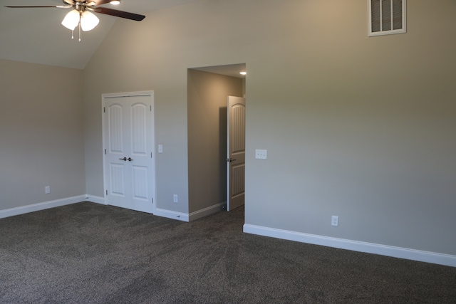 unfurnished bedroom with high vaulted ceiling, dark colored carpet, and ceiling fan