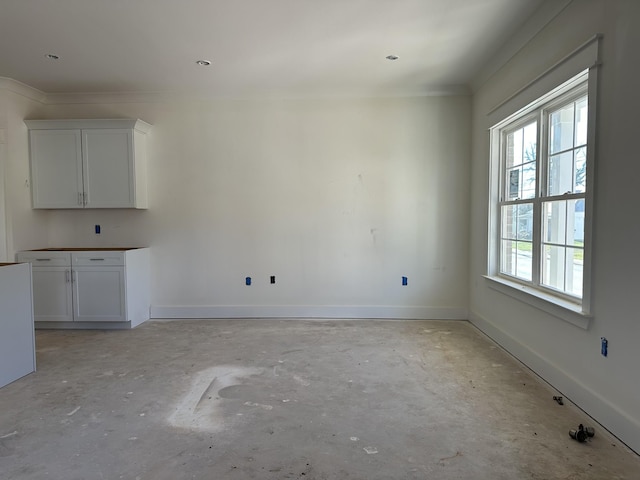 unfurnished dining area with crown molding