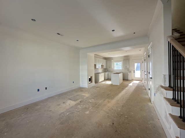 unfurnished living room featuring ornamental molding