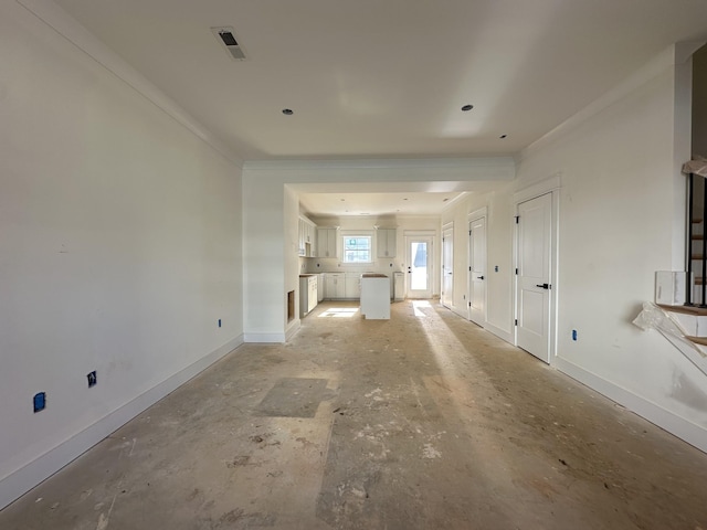 unfurnished living room featuring crown molding