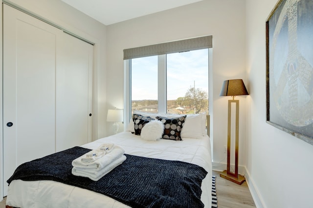 bedroom featuring light hardwood / wood-style floors and a closet