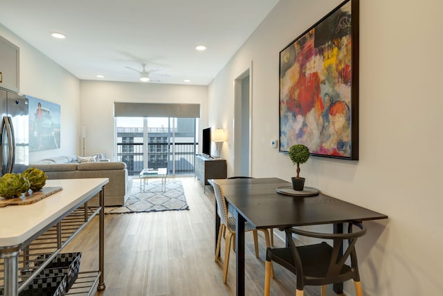 dining space featuring ceiling fan and light wood-type flooring