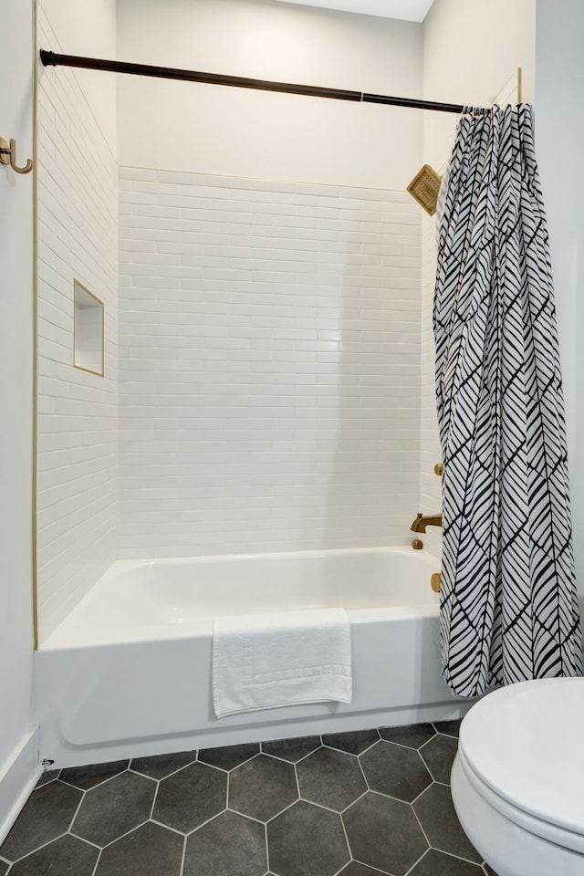 bathroom featuring toilet, tile flooring, and shower / bathtub combination with curtain