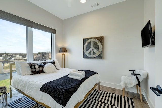 bedroom featuring ceiling fan and light hardwood / wood-style flooring