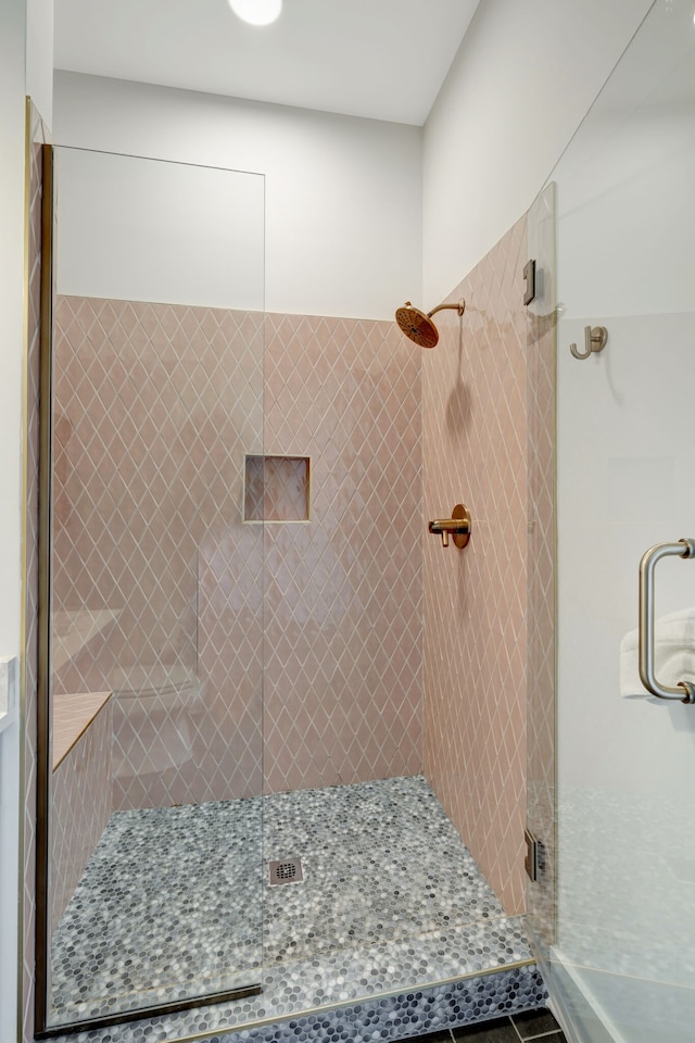 bathroom featuring tile floors and an enclosed shower