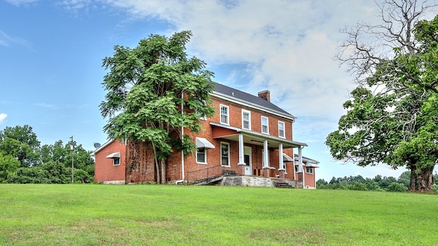 rear view of house with a lawn