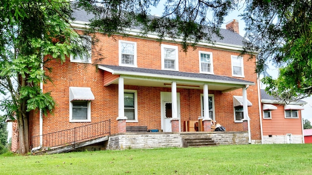 view of front facade with a porch and a front lawn