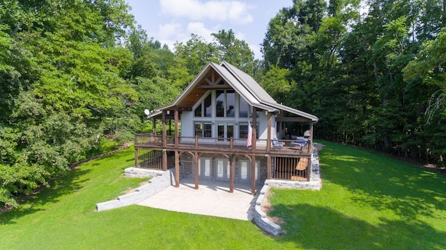 rear view of property featuring a yard and a patio area