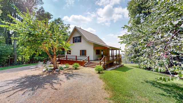 view of front facade featuring a wooden deck and a front yard