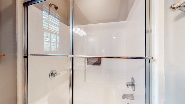 bathroom with shower / bath combination with glass door