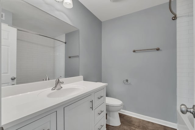 bathroom with hardwood / wood-style flooring, vanity, and toilet