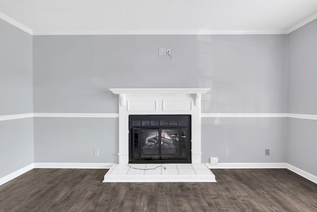 interior details featuring a textured ceiling, hardwood / wood-style floors, and a tiled fireplace