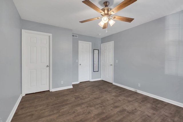 unfurnished bedroom featuring ceiling fan and dark hardwood / wood-style floors