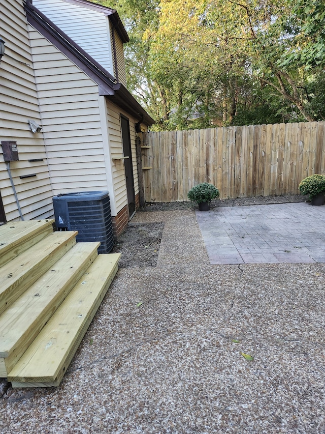 view of yard featuring central AC and a patio area