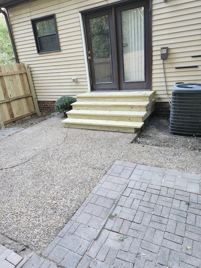 entrance to property featuring central air condition unit and a patio area