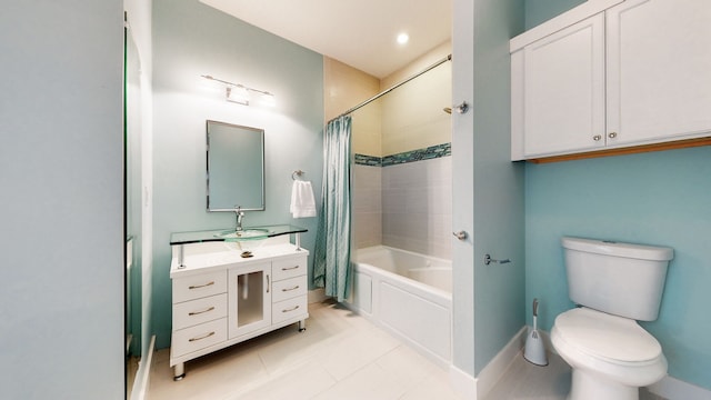 full bathroom with tile floors, large vanity, shower / bath combo with shower curtain, and toilet