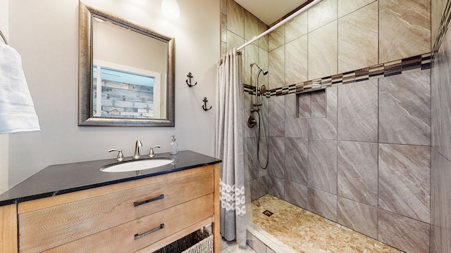 bathroom featuring a shower with curtain and vanity with extensive cabinet space