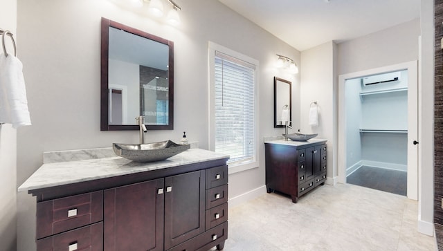 bathroom featuring tile floors and double sink vanity