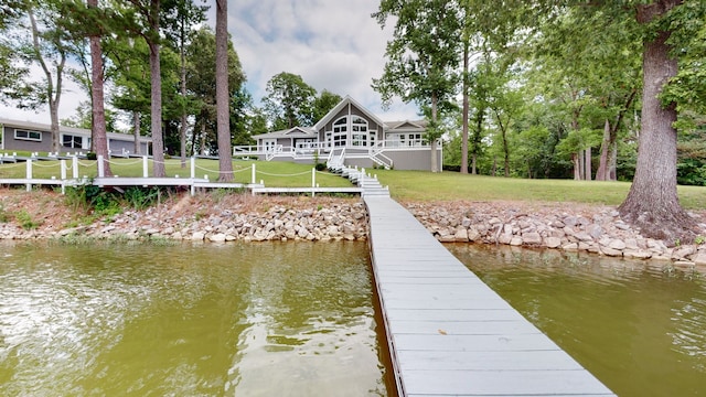 dock area featuring a water view and a yard