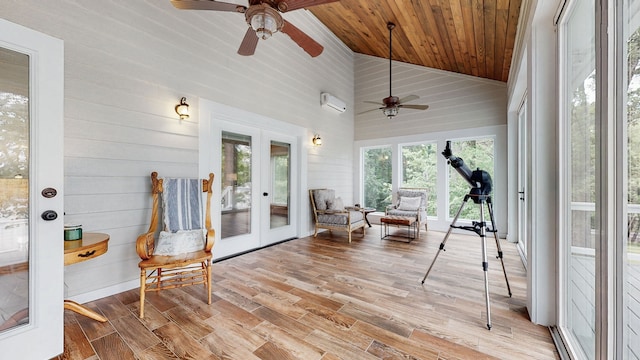 sunroom / solarium with an AC wall unit, lofted ceiling, ceiling fan, wood ceiling, and french doors