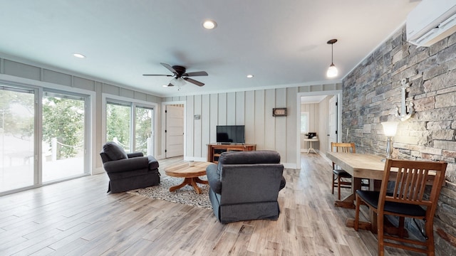 living room with ceiling fan and light hardwood / wood-style flooring