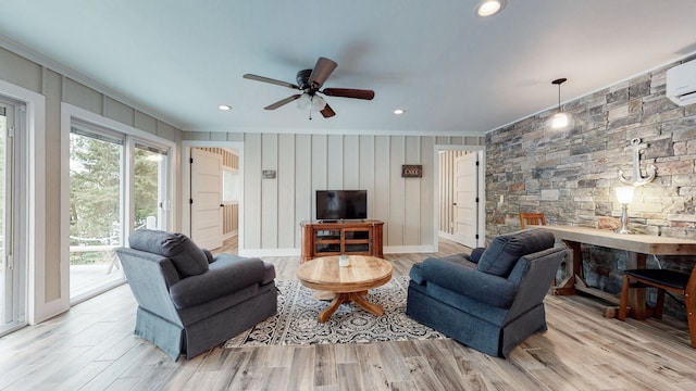 living room with ceiling fan, light hardwood / wood-style flooring, and ornamental molding