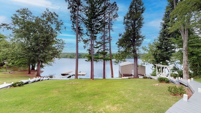 view of yard featuring a water view and a boat dock