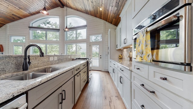 kitchen featuring wood ceiling, white cabinets, appliances with stainless steel finishes, and lofted ceiling