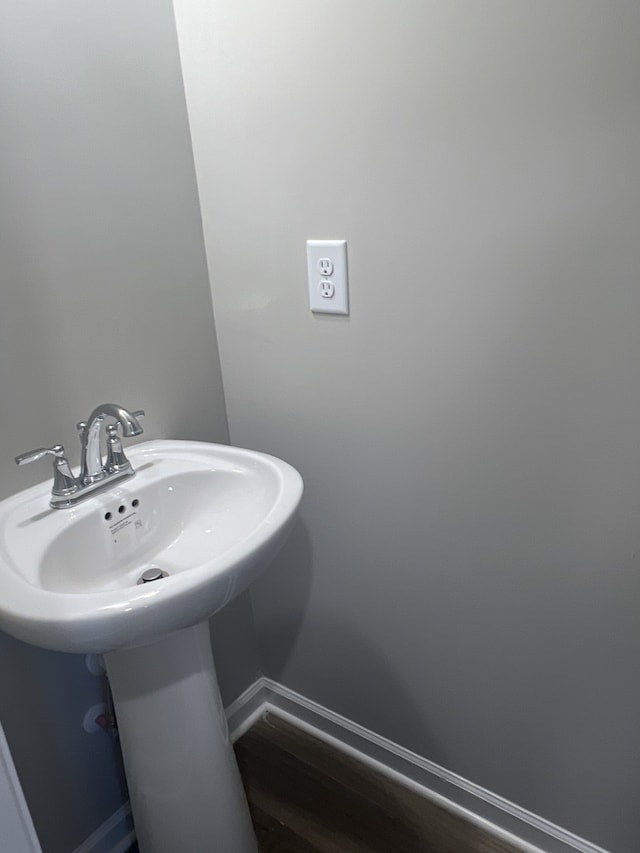 bathroom with hardwood / wood-style flooring and sink