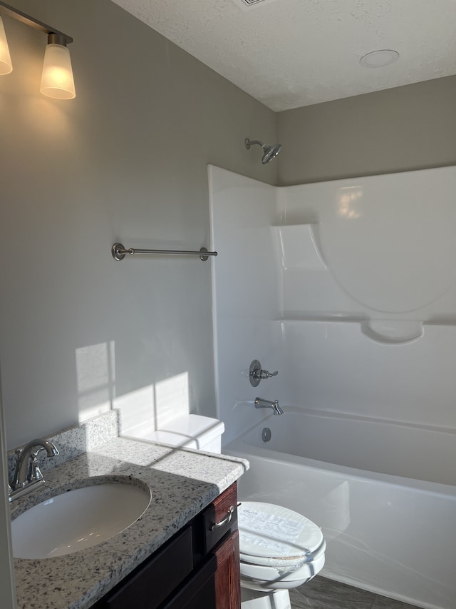 full bathroom with washtub / shower combination, vanity, and toilet