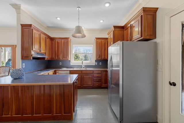 kitchen featuring kitchen peninsula, dark tile floors, appliances with stainless steel finishes, tasteful backsplash, and decorative light fixtures