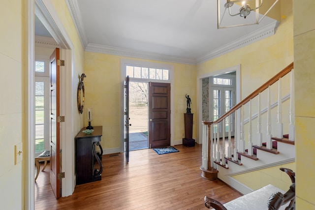 foyer featuring plenty of natural light, a notable chandelier, and light wood-type flooring