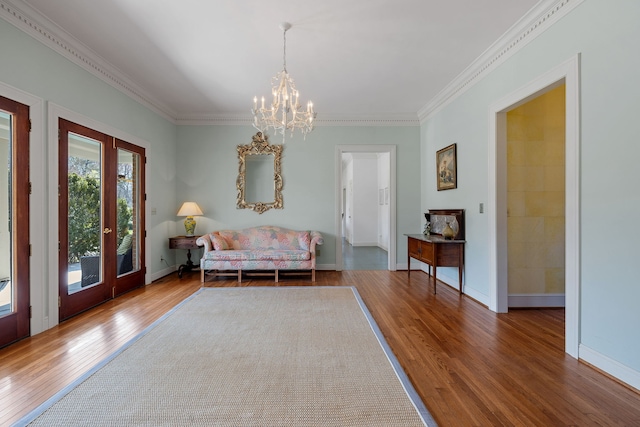 sitting room featuring crown molding, dark hardwood / wood-style floors, and a chandelier