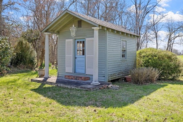 view of outdoor structure featuring a lawn