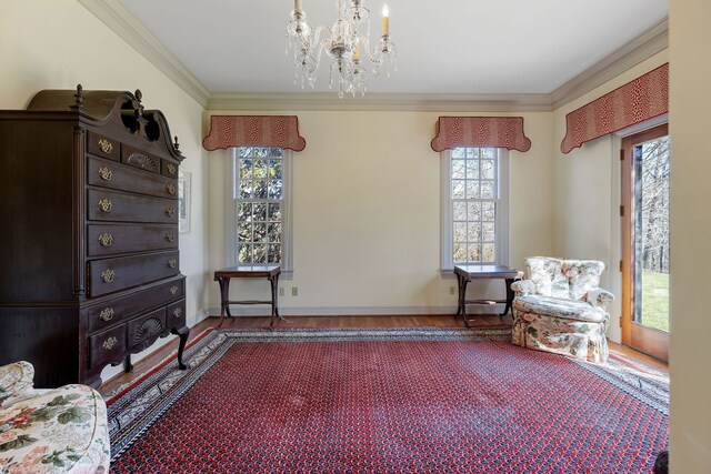 sitting room featuring dark wood-type flooring, a chandelier, and a healthy amount of sunlight