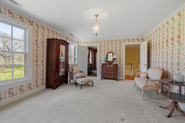 sitting room with crown molding, light colored carpet, and a healthy amount of sunlight