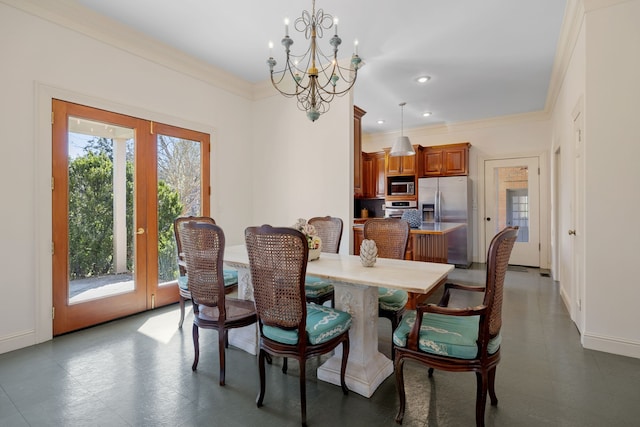 dining space featuring dark tile flooring, ornamental molding, a notable chandelier, and a wealth of natural light