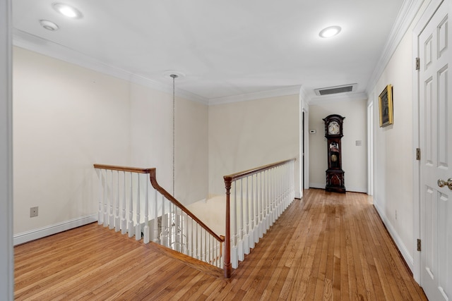 corridor with crown molding and light wood-type flooring