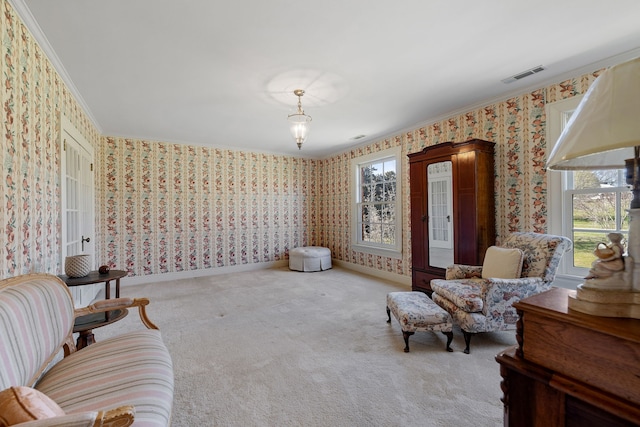 sitting room featuring light colored carpet and ornamental molding