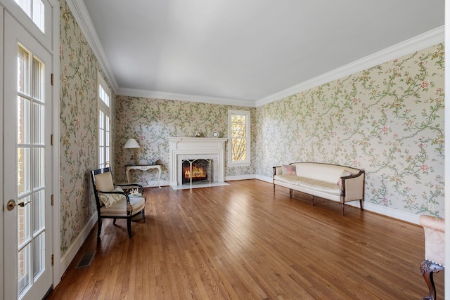 sitting room featuring ornamental molding and dark hardwood / wood-style flooring