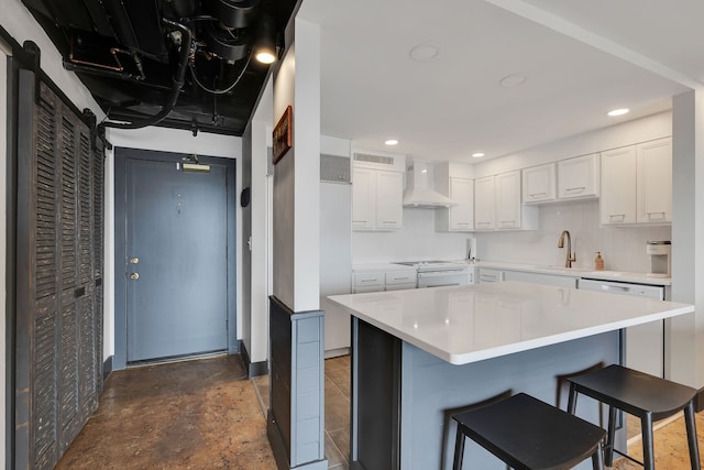 kitchen with white cabinets, premium range hood, stovetop, and a breakfast bar area