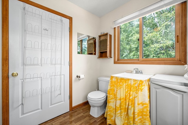 bathroom featuring sink, toilet, and hardwood / wood-style flooring