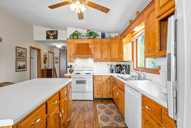 kitchen featuring white appliances, lofted ceiling, sink, ceiling fan, and custom range hood