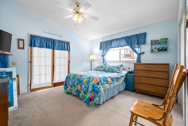 bedroom with a textured ceiling, ceiling fan, lofted ceiling, and carpet floors