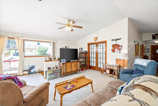 living room featuring ceiling fan, french doors, carpet, and vaulted ceiling