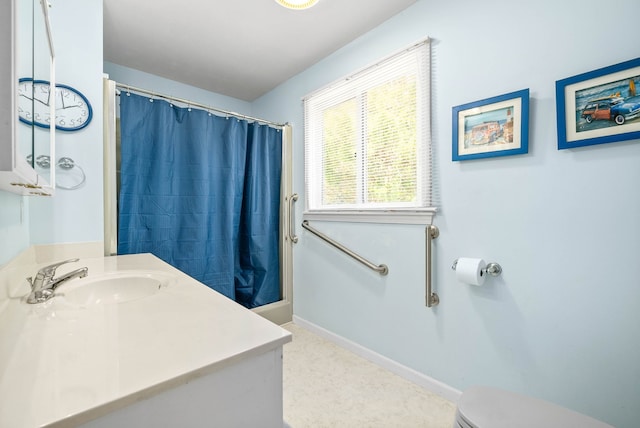 bathroom featuring vanity, toilet, and walk in shower