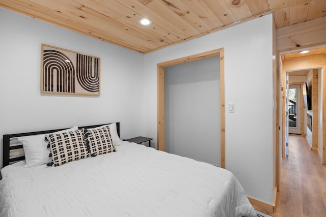 bedroom featuring wood ceiling and light wood-type flooring