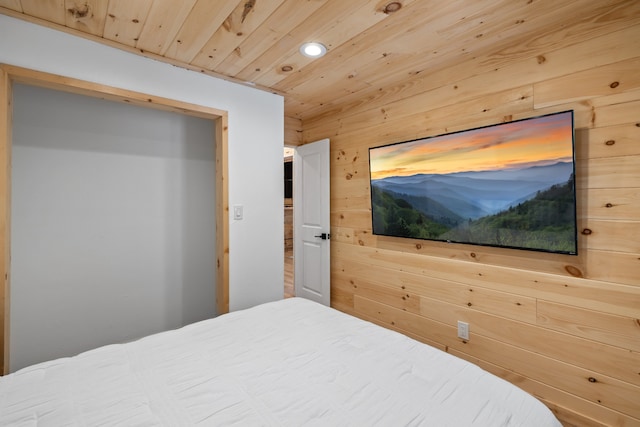 bedroom with wood walls and wood ceiling