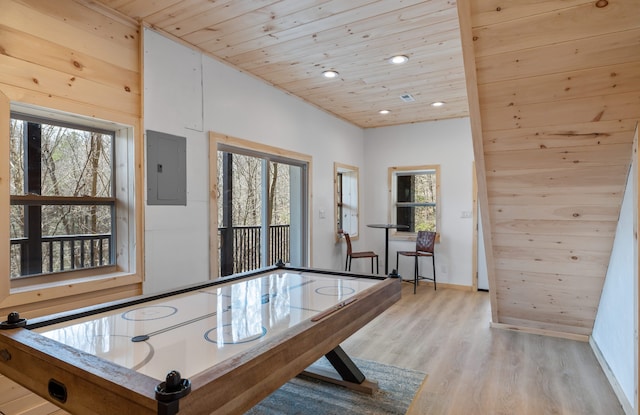 playroom with wood walls, wooden ceiling, and light hardwood / wood-style floors