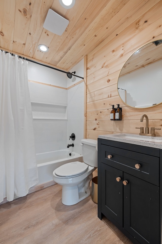 full bathroom featuring vanity, hardwood / wood-style floors, wood walls, toilet, and shower / bath combination with curtain